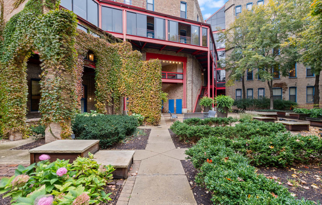the courtyard of a building with plants and a sidewalk
