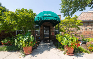 A welcoming clubhouse with a classic brick exterior and well-kept landscaping.