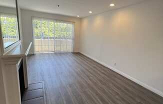 Living Room with Hardwood Floors, Fireplace and Patio Door