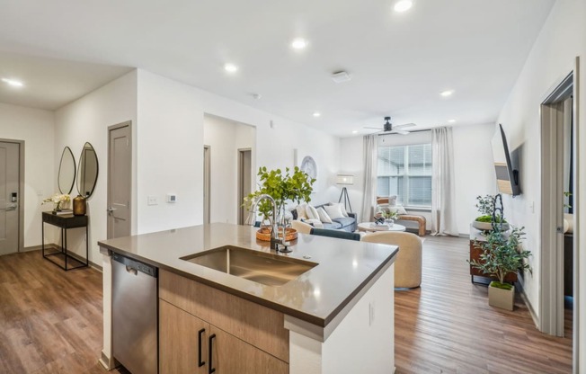 a kitchen with an island and a living room with a couch