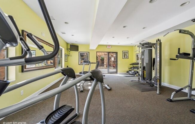 a gym with weights and other equipment in a building