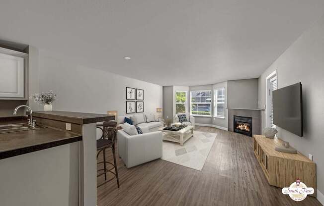 A modern living room with a fireplace and a television.