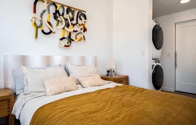 a bedroom with a bed and a wall with a rack of shoes on it at Slabtown Square Apartments, Portland , Oregon
