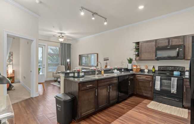 a kitchen with a large island and a living room