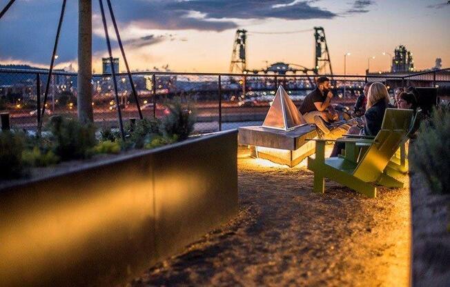 People Sitting Around Fire Pit at Yard Apartments