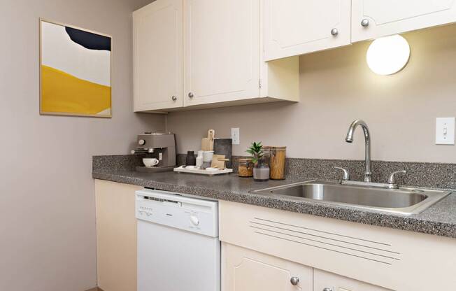 a kitchen with white cabinets and a sink
