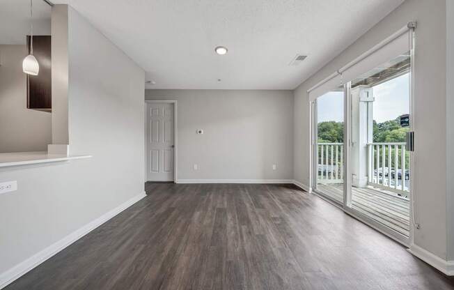 A room with a sliding glass door leading to a balcony.