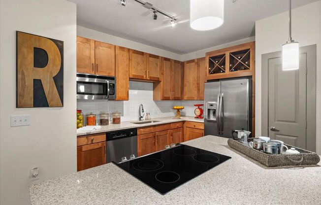 a kitchen with wooden cabinets and a granite counter top