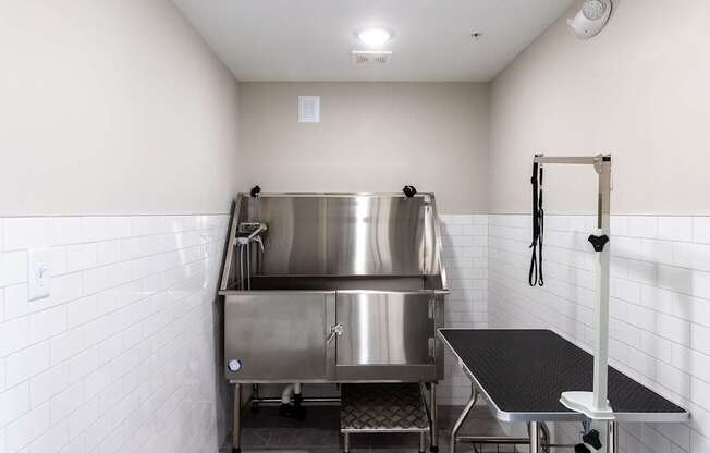 A stainless steel kitchen with a large pot on the stove.