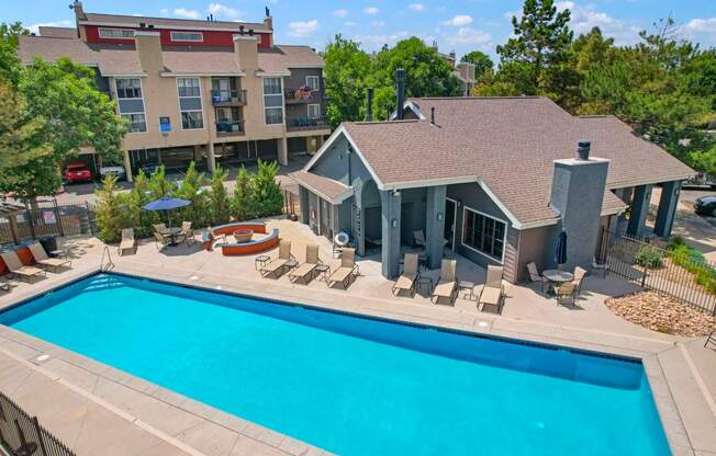 A large swimming pool in front of a house.