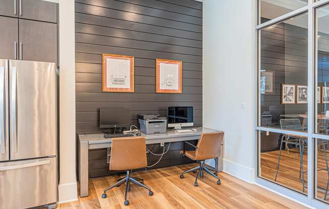 a home office with a desk and a refrigerator
