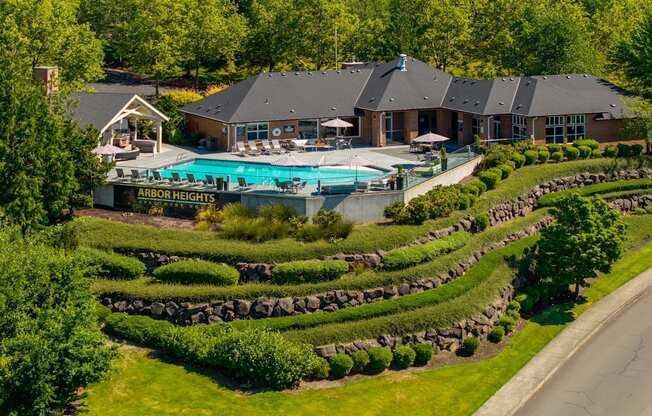 A resort with a pool and a sign that says Arbor Heights.