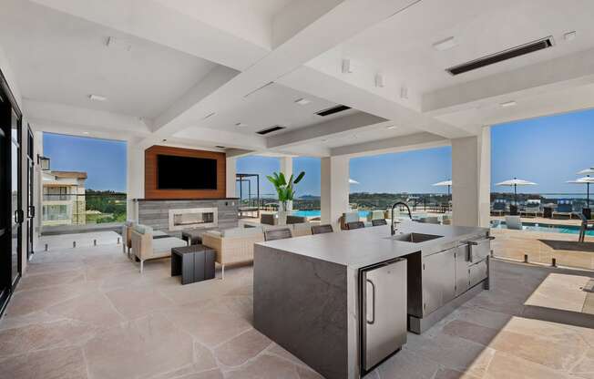 a large living room with a kitchen and a television