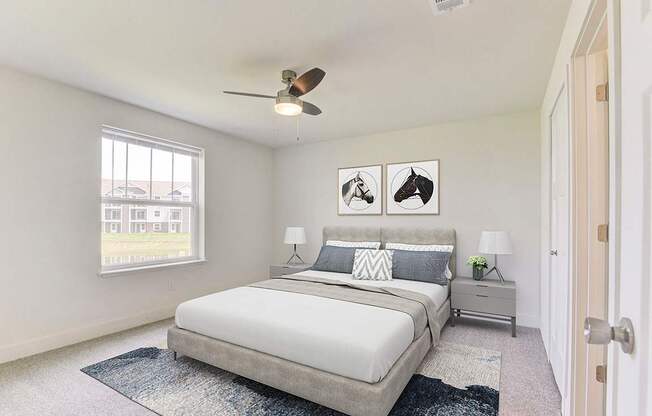 A bedroom with a bed, nightstands, a window and ceiling fan at Stoney Pointe Apartment Homes, Wichita, KS
