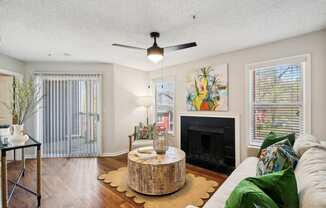 a living room with a fireplace and a couch and a table at Elme Druid Hills, Atlanta, Georgia