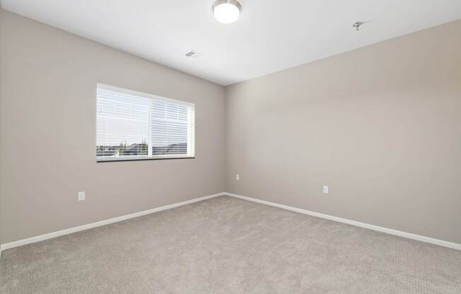 A room with a window and a ceiling light.