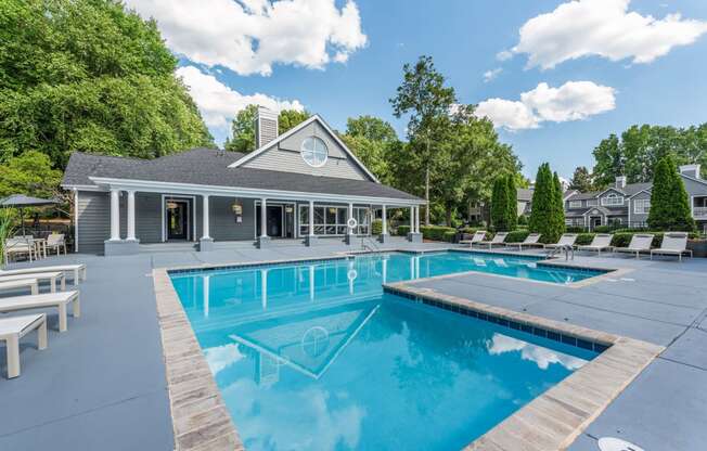 a swimming pool with a house in the background