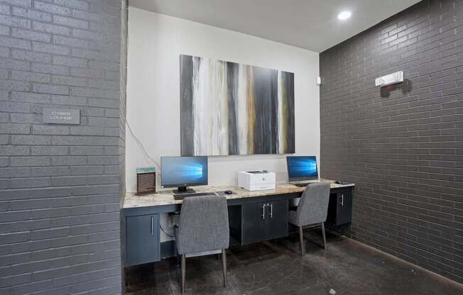 A room with a desk and two computers.