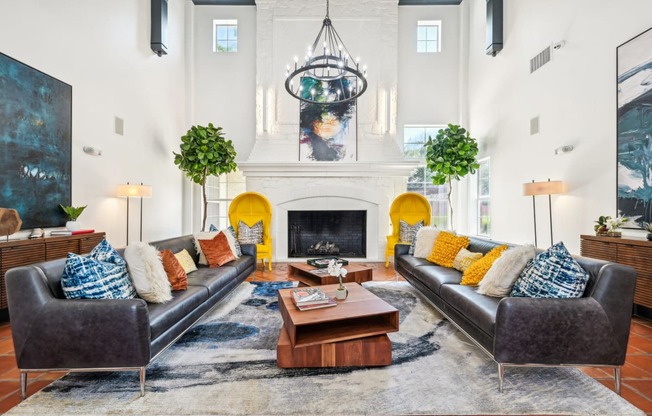 a living room with two leather couches and a fireplace