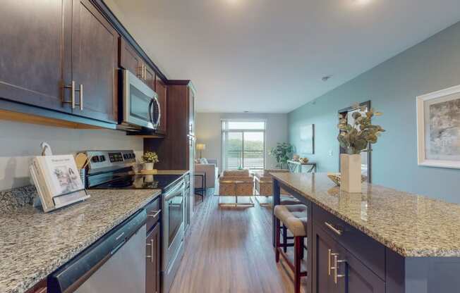 a kitchen with granite countertops and stainless steel appliances