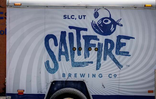 A truck with a blue fish and the words