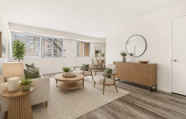 A living room with a white sofa, a wooden coffee table, and a white chair.