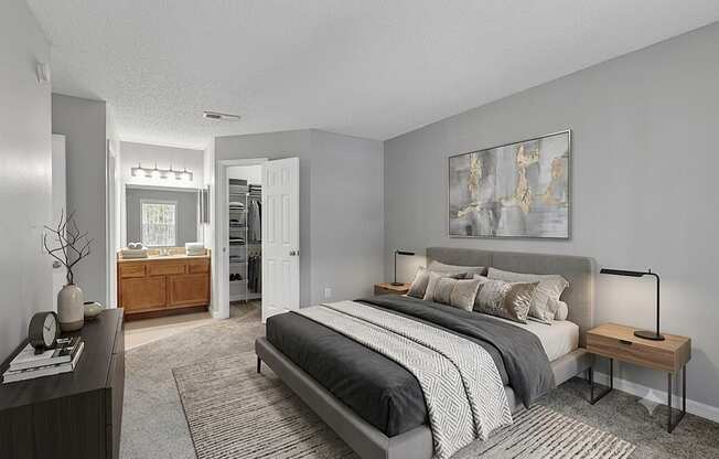 A bedroom with a large bed and a painting on the wall.