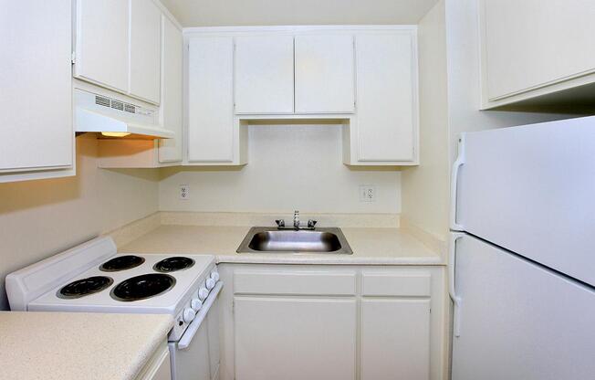 a white stove top oven sitting inside of a kitchen