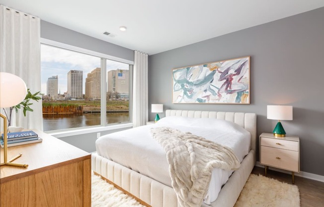 a bedroom with a large window and a white bed at Dey & Bergen, New Jersey, 07029