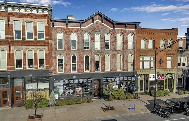 a large brick building on the corner of a city street at The Granite Works Apartments , Buffalo, New York