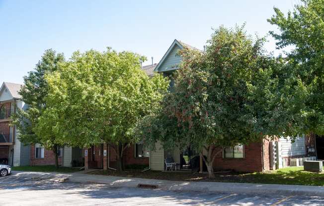 Large Trees Covering Greenfield Apartment Building