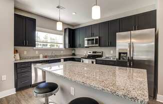 a kitchen with granite counter tops and stainless steel appliances