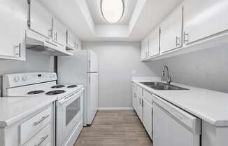 a white kitchen with white appliances and white cabinets