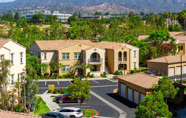 A view of a residential area with houses and cars.