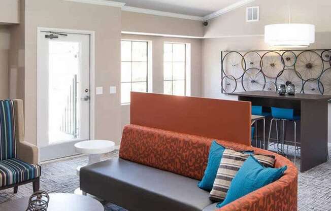 A living room with a sofa, armchair, and coffee table.