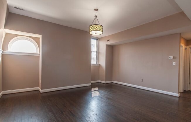 Spacious living room with hardwood floors and window light