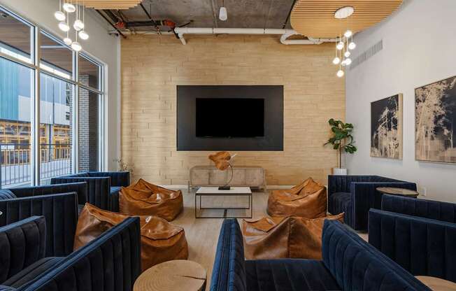 a living room with couches and chairs and a television on the wall