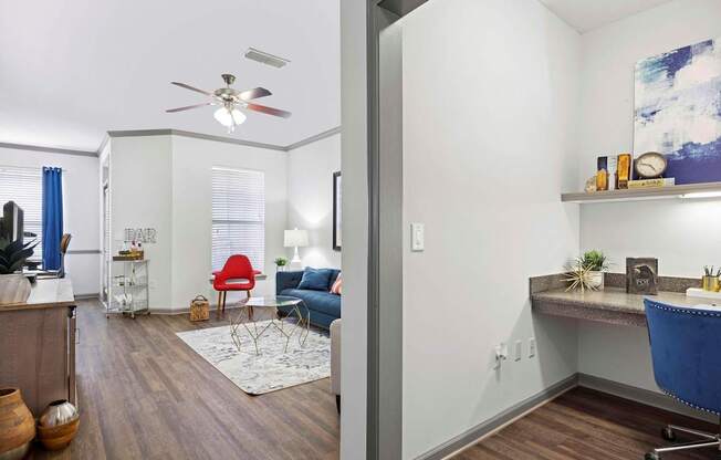 A living room with a red chair and a blue chair.