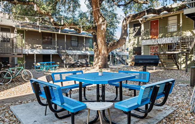 our yard is full of tables and chairs and a grill