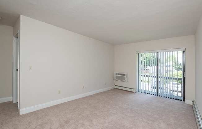 Quincy Commons one bedroom apartment with plush carpeting and balcony