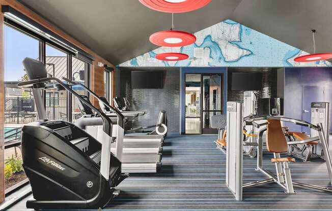 A gym with treadmills and exercise equipment.