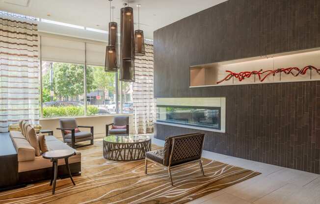 a living room with a couch and chairs and a fireplace