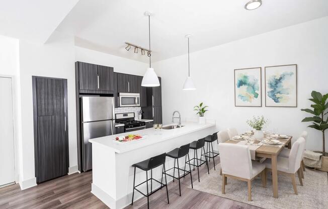 Spacious kitchen with extended island seating, clean finishes, and an open flow into the dining area.