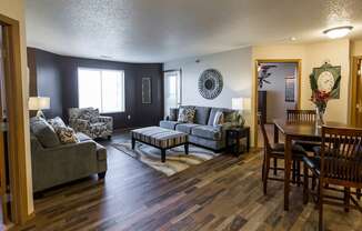 a living room and dining room with furniture and a table