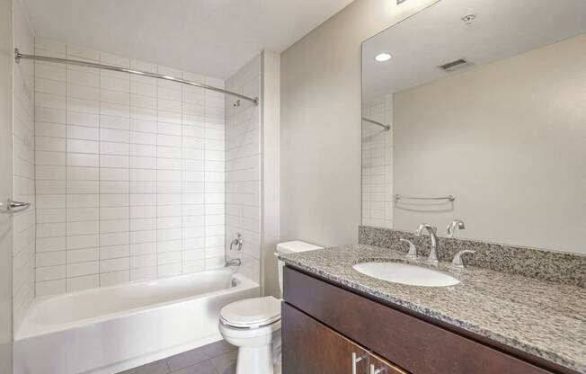 a bathroom with a sink and a toilet and a bath tub