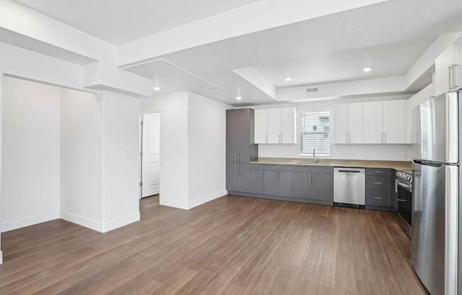 A kitchen with wooden floors and stainless steel appliances.