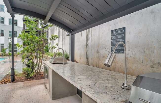 the kitchen has a concrete countertop and a sink with a large counter