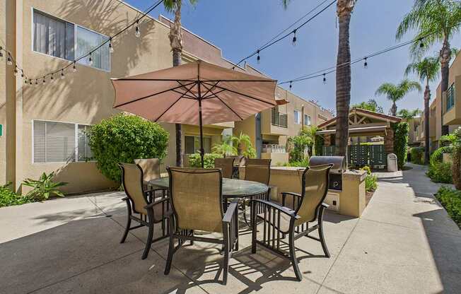A patio with a table and chairs under a canopy.