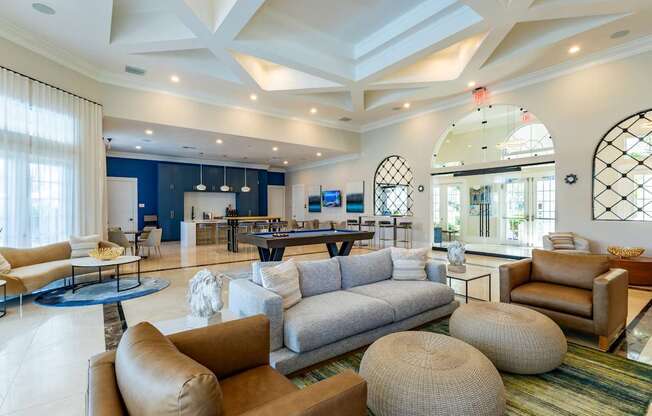 A spacious living room with a variety of seating options and a large window.