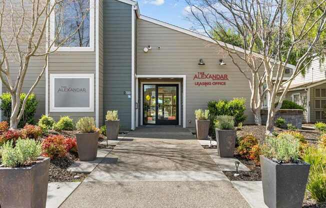 The front of a building with the name Alexandre Leasing Office on it.